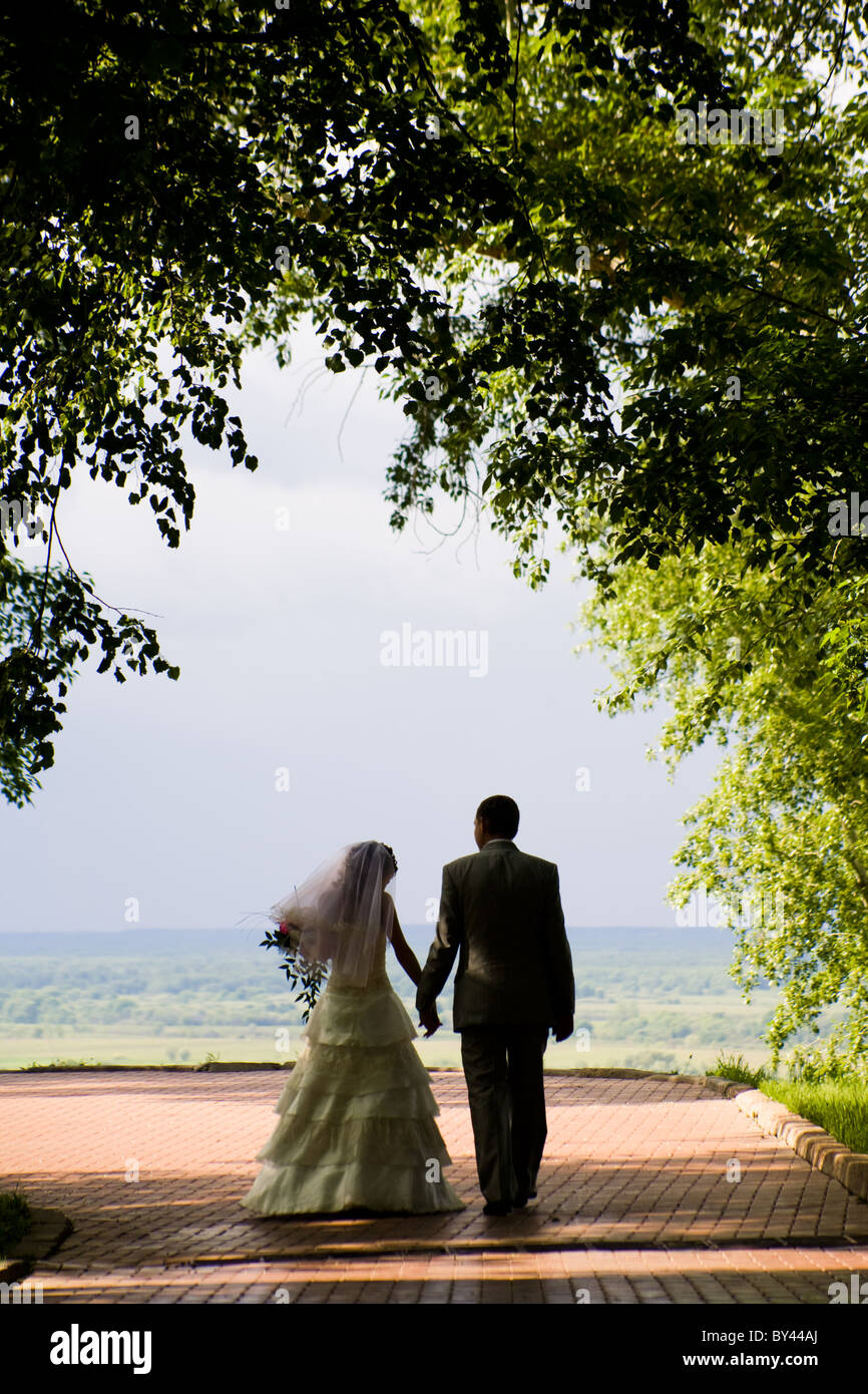 Couple walking hand in hand in park hi-res stock photography and images ...