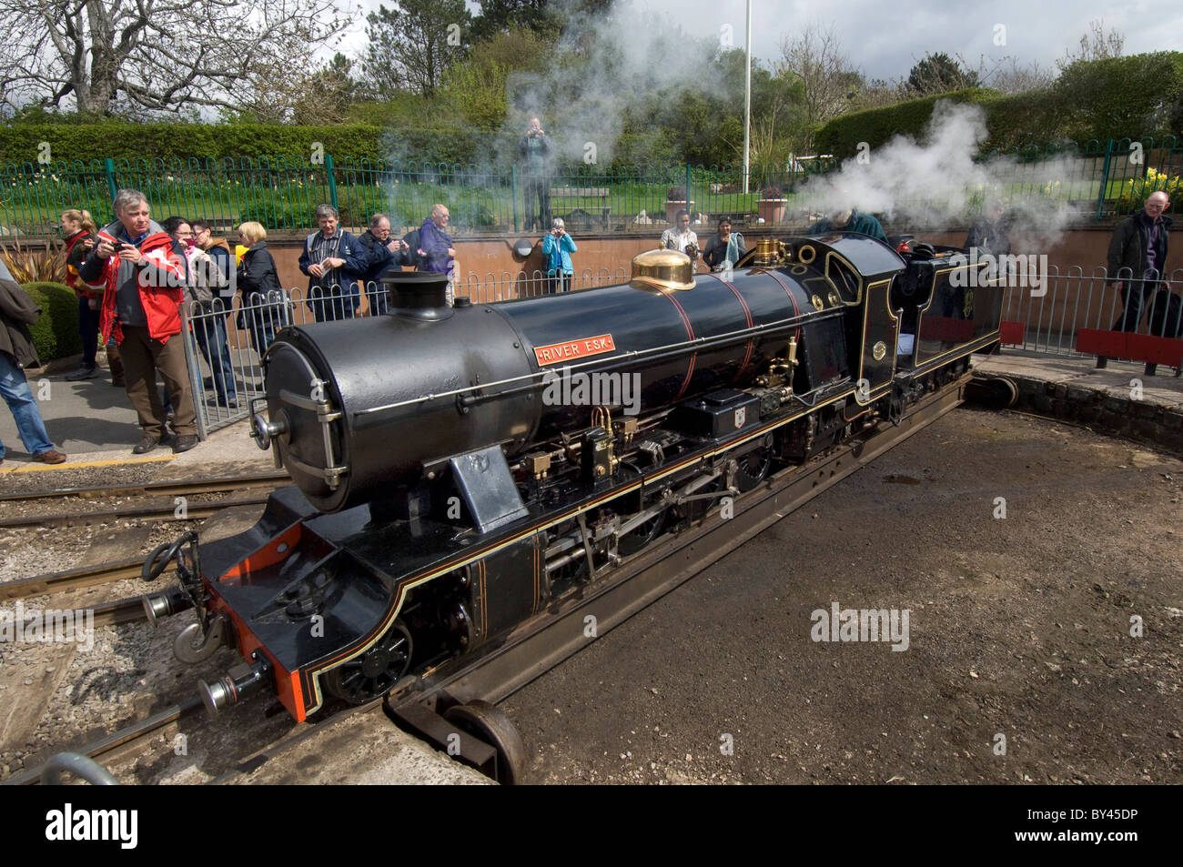 The driver of 15-inch gauge narrow gauge steam locomotive "River Esk" uses the turntable at Ravenglass to turn his engine round Stock Photo