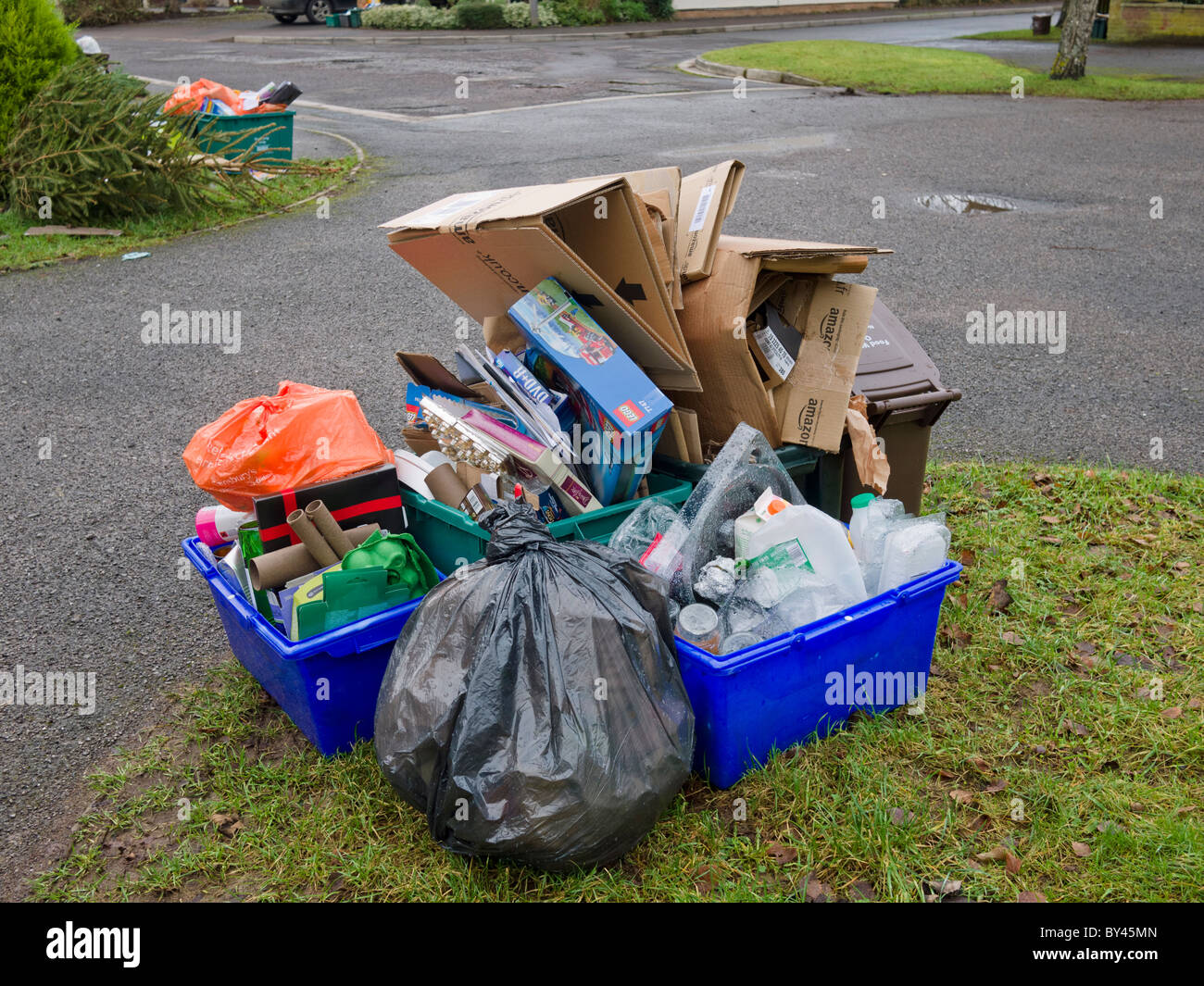 Overflowing kerbside recycling awaiting collection after delays due to poor weather. Stock Photo