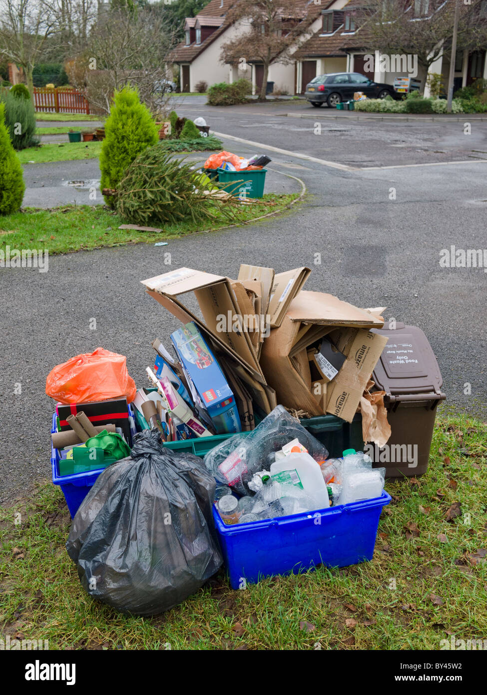Overflowing kerbside recycling awaiting collection after delays due to poor weather. Stock Photo
