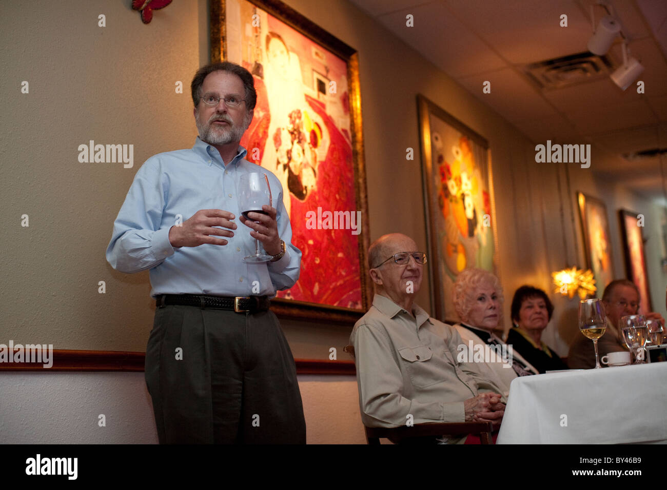 55-year-old Anglo man proposes toast to his father during 90th birthday party at a restaurant in Austin Texas USA Stock Photo