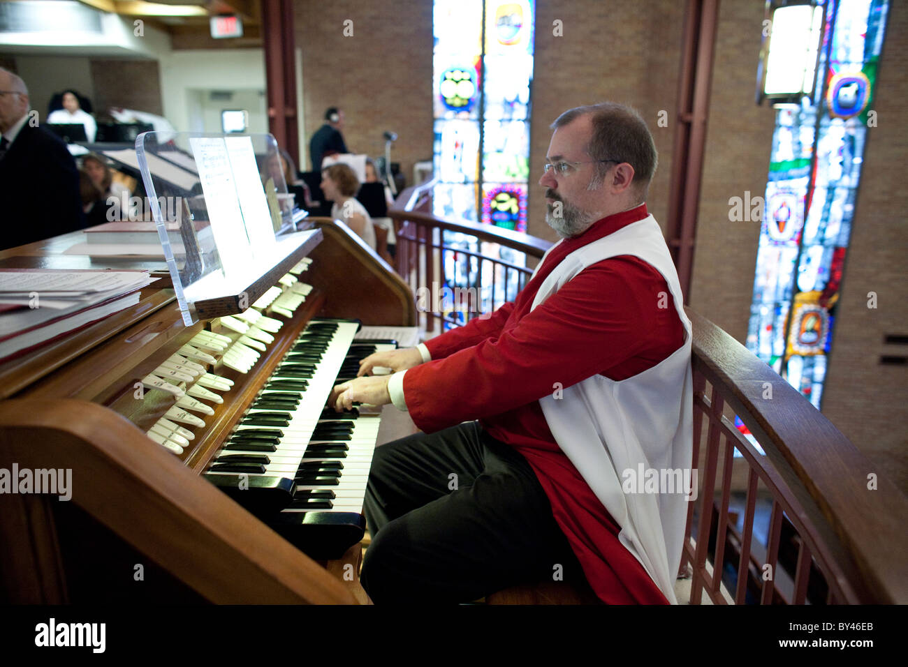 Organist wearing choir robe plays during Sunday service at St. Martin's Lutheran Church in