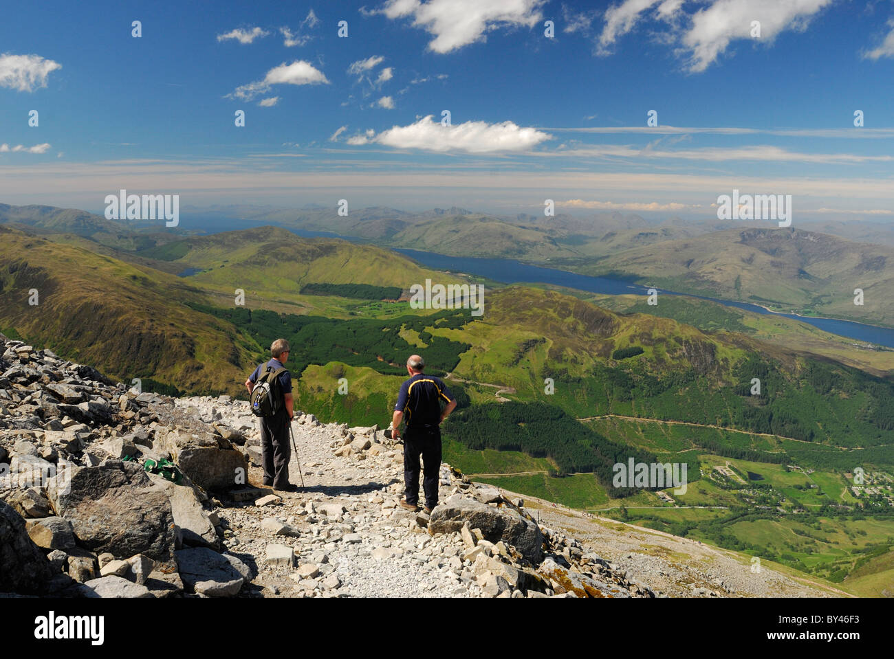 Walkers admiring the view towards Loch Linnhe from Ben Nevis in summer in the Scottish Highlands Stock Photo