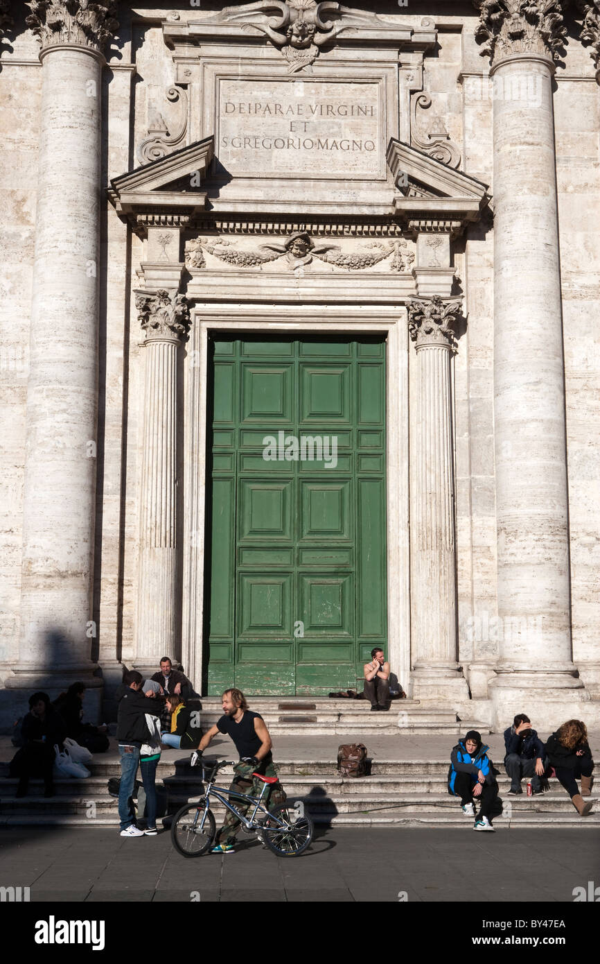 People tourists relaxing sitting in front of Chiesa Nuova church ...