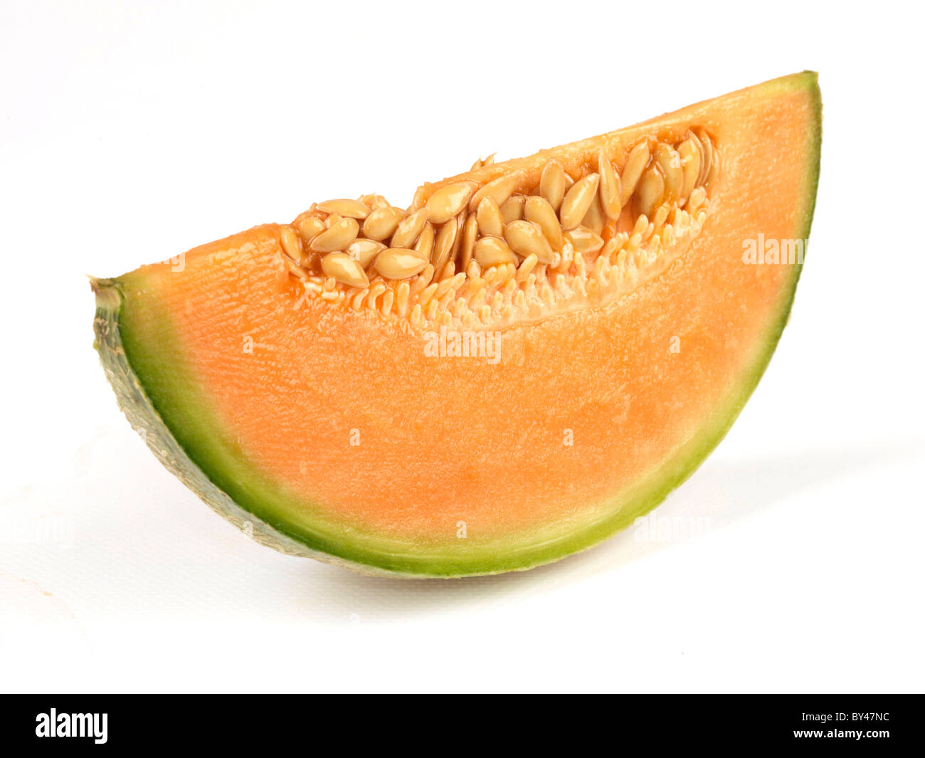 Freshly Cut Segments of A Fresh Healthy Orange Cantaloupe Melon In Close Up Against A White Background With Copy Space And No People Stock Photo