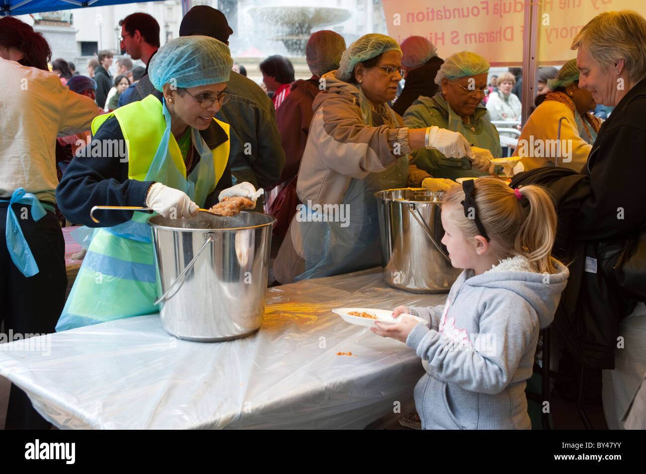Child receiving free meal at celebration of  Ratha Yatra The Hindu Festival of Chariots,Trafalgar Square,London 2010 Stock Photo