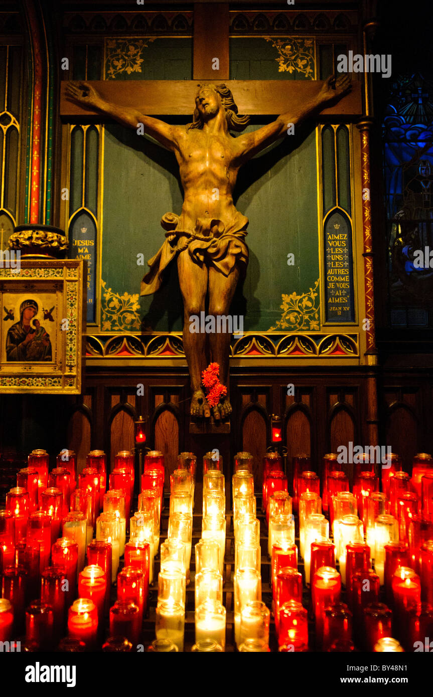 Candles and statues in the ornately decorated Notre-Dame Basilica in ...