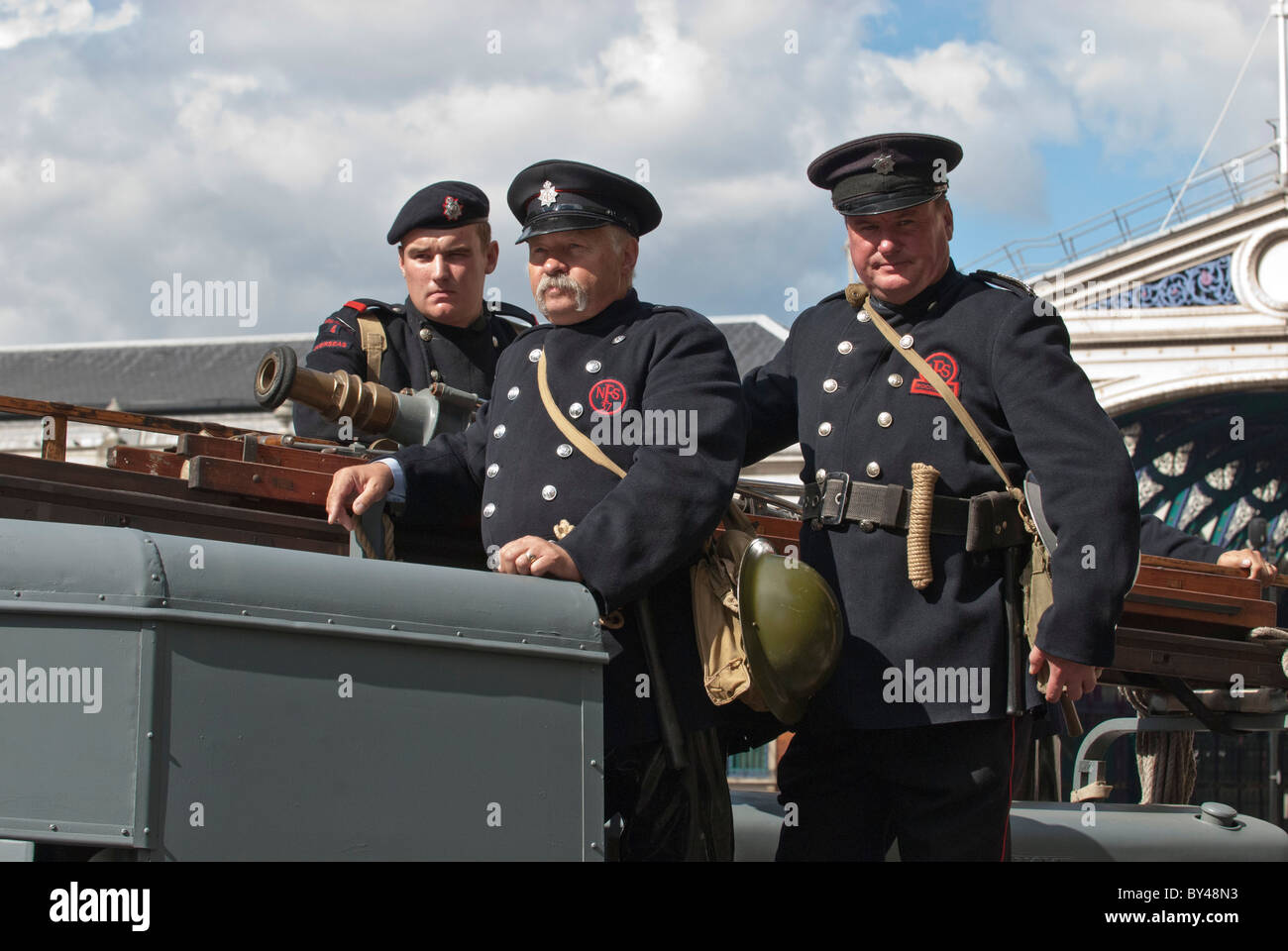 Firefighters dressed in uniforms second world war Austin Fire engine
