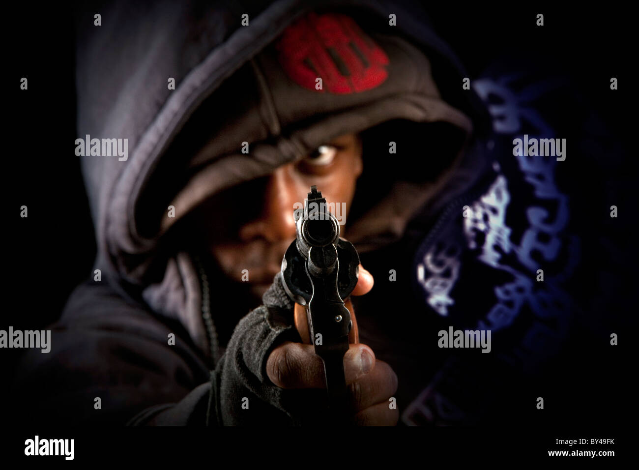 Young black male model posing with a gun Stock Photo