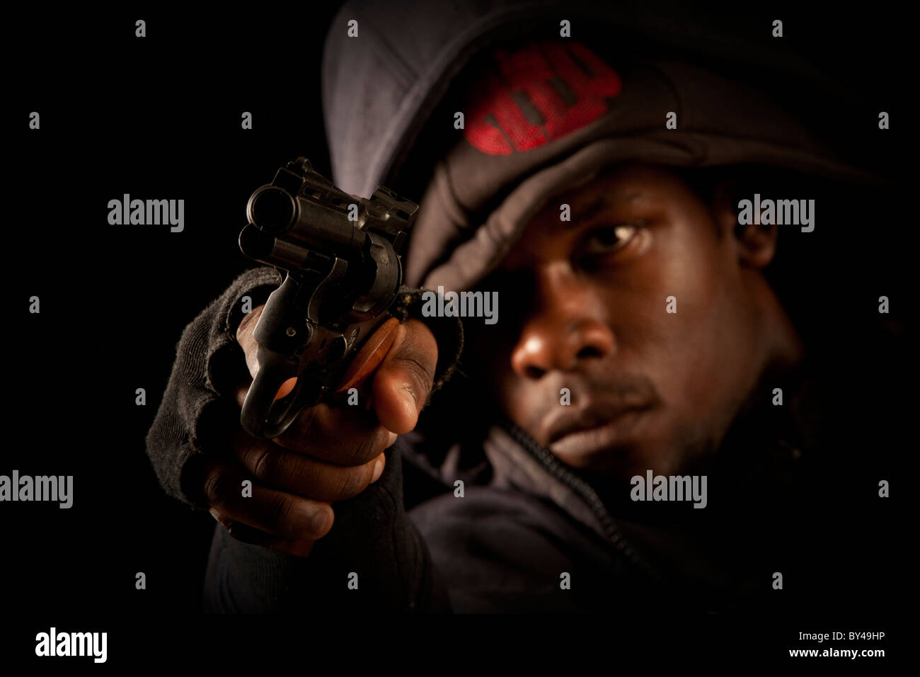 Young black male model posing with a gun Stock Photo