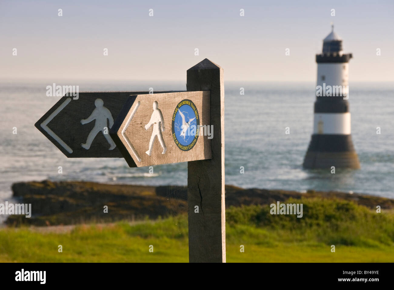 Isle of Anglesey Coastal Path Sign & Penmon Lighthouse, Penmon Point, Anglesey, North Wales, UK Stock Photo