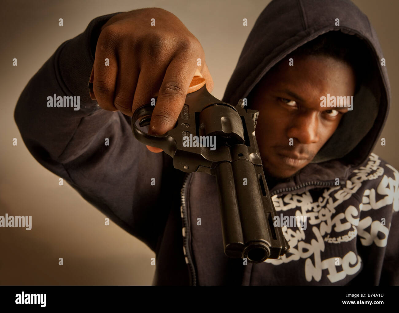 Young black male model posing with a gun Stock Photo