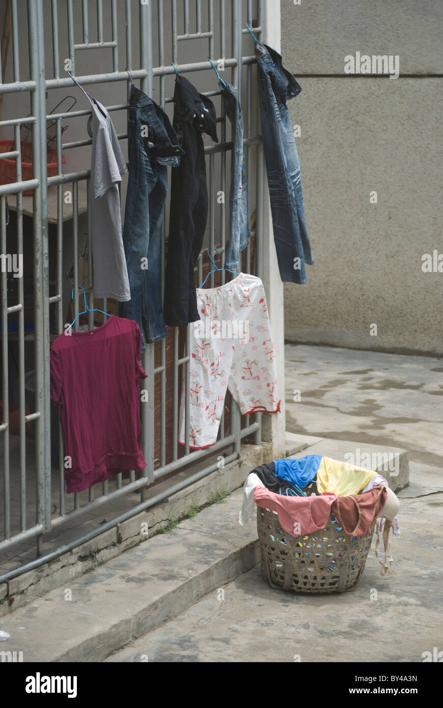 Chinese hands there clothes for sun-drying in front of their houses. Stock Photo