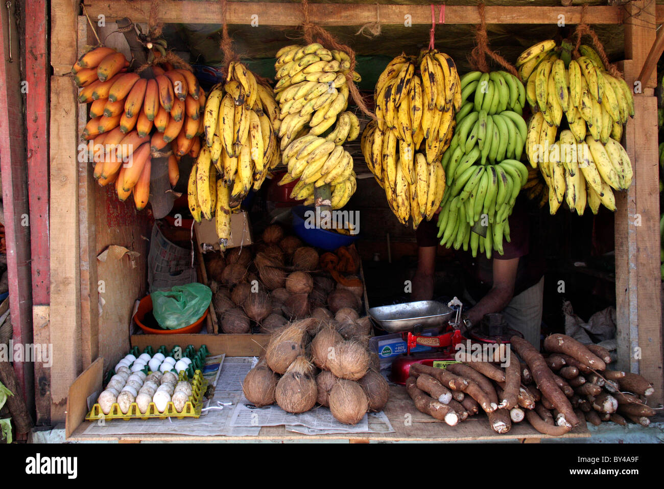 different  types of colourful banana's hanged and vegetables displayed from a vegetable shop Stock Photo