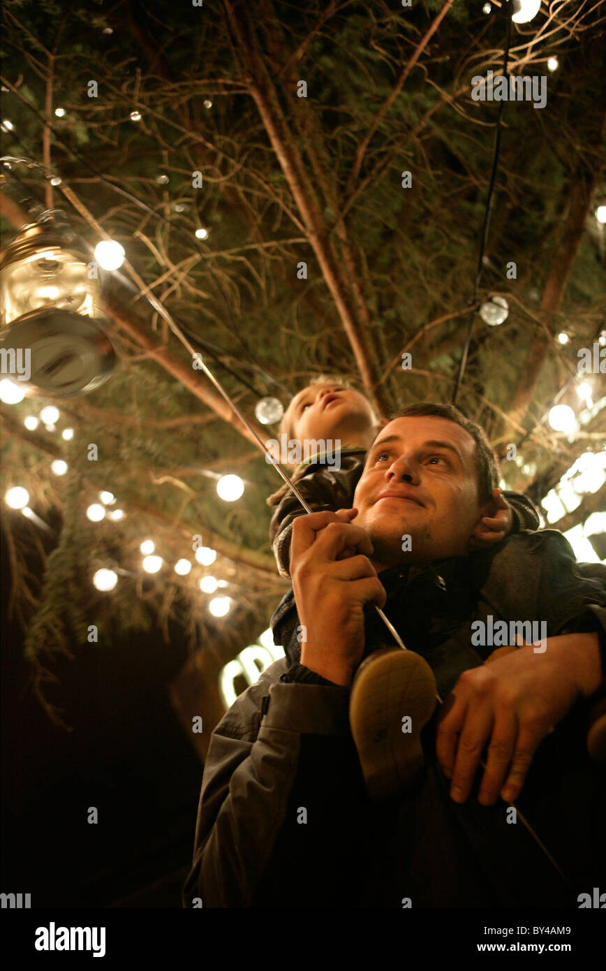 Father and child at lantern procession in Cardiff Bay at Christmas