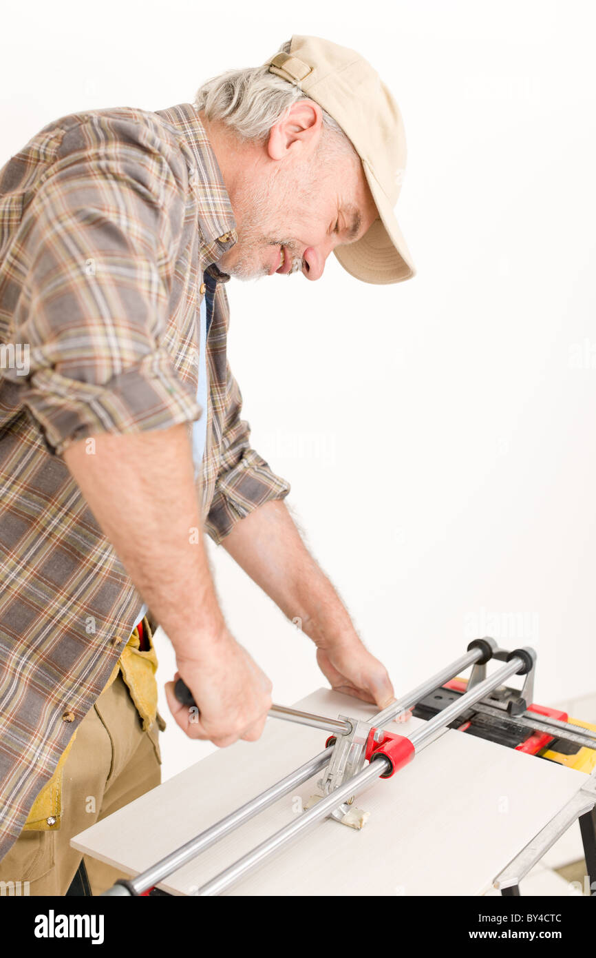 Home improvement - handyman cut tile with cutter Stock Photo