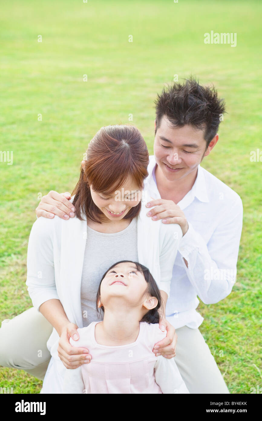 Family with hands on shoulders Stock Photo