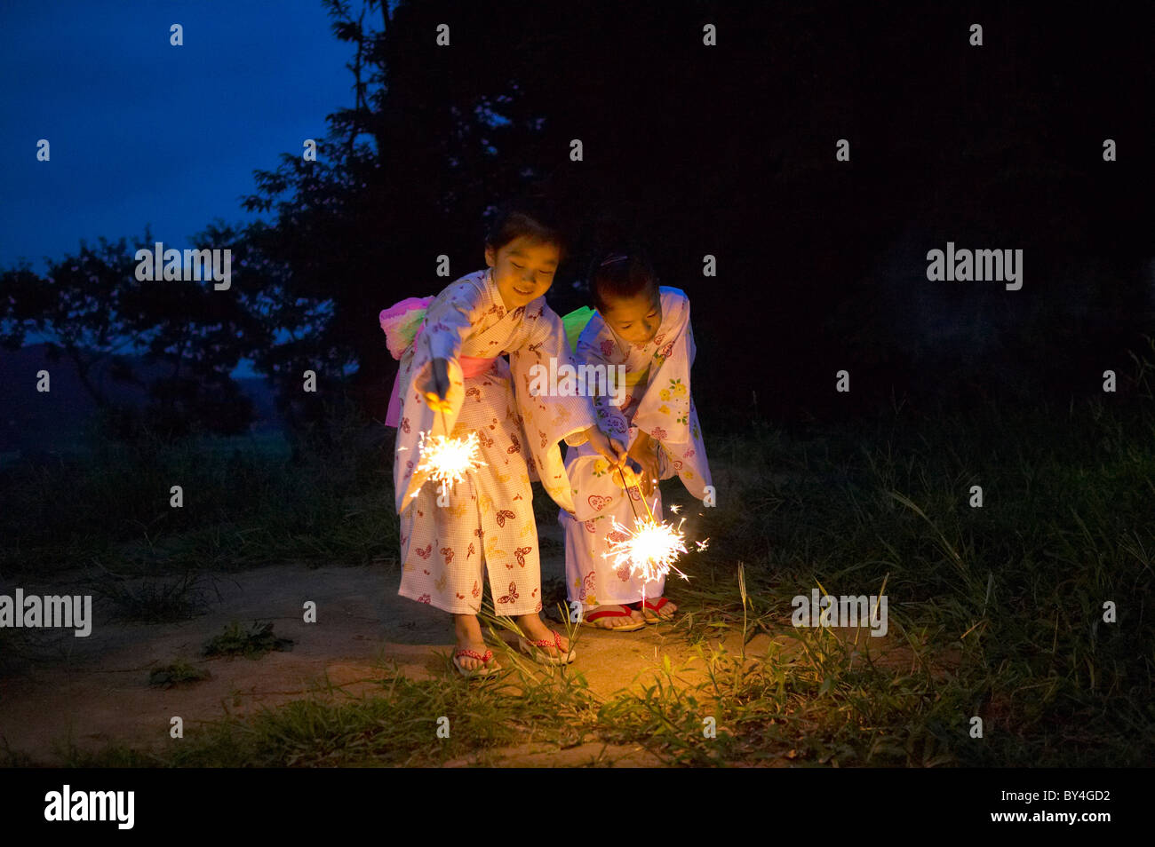 Two Girls in Kimonos Holding Sparkles Stock Photo