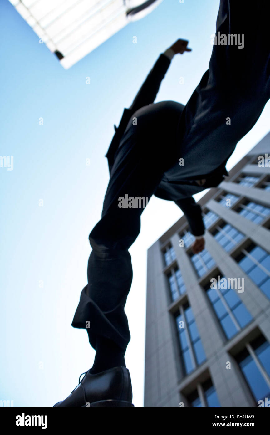 Businessman jumping, low angle view Stock Photo