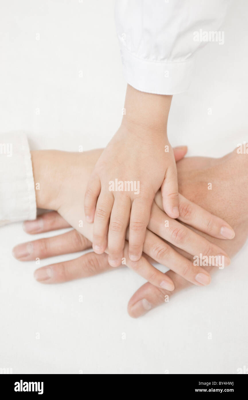 Family with hand on top of each other Stock Photo