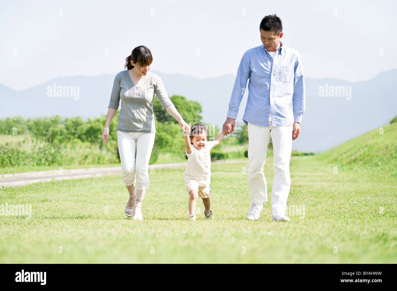 Family holding hands and walking Stock Photo