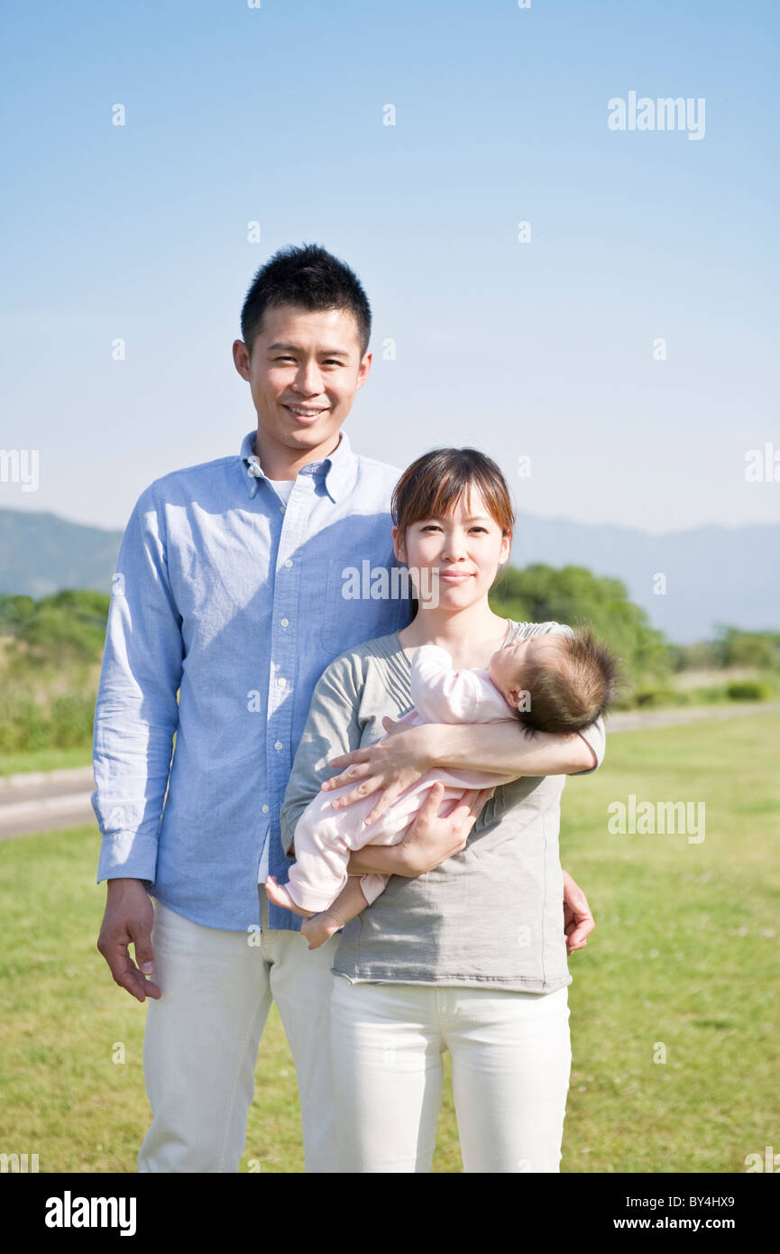 Parents holding a baby Stock Photo