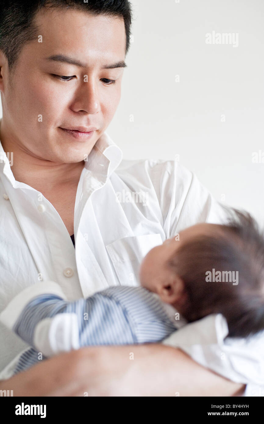 Father carrying a baby boy Stock Photo Alamy