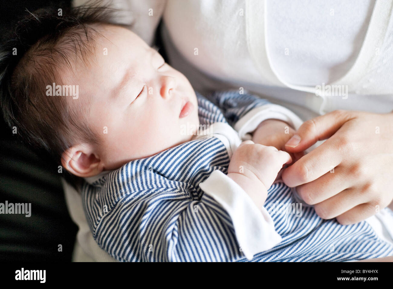 Mother carrying a baby boy Stock Photo Alamy