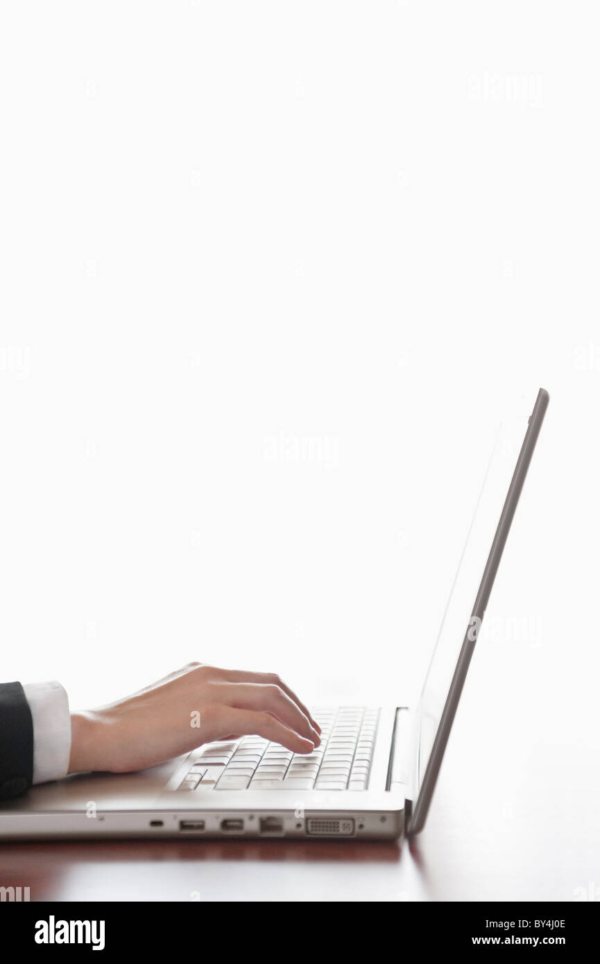 Hand typing a laptop Stock Photo - Alamy