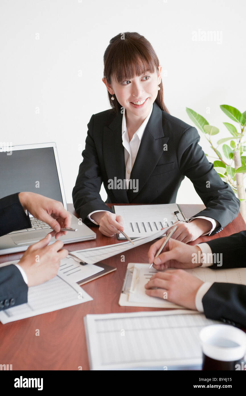 Businessmen and businesswoman having a meeting Stock Photo - Alamy