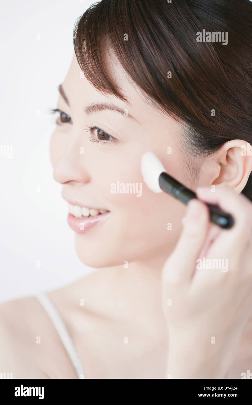 Woman applying make up Stock Photo