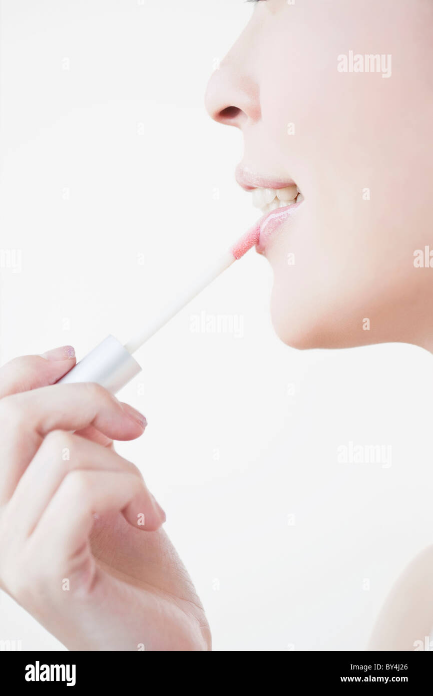 Woman wearing a lip gloss Stock Photo