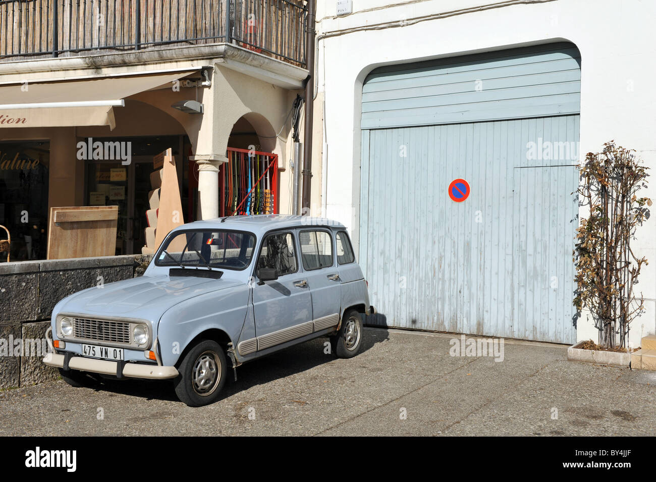 Classic Renault car parked outside a garage in France Stock Photo