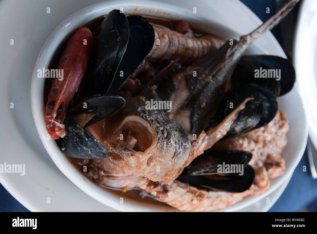 Livorno fish stew known as “Cacciucco” containing five different kinds of fish served in a soup dish Stock Photo