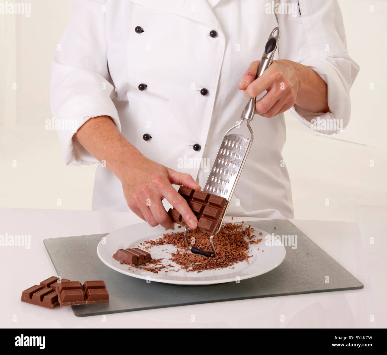 CHEF GRATING CHOCOLATE Stock Photo