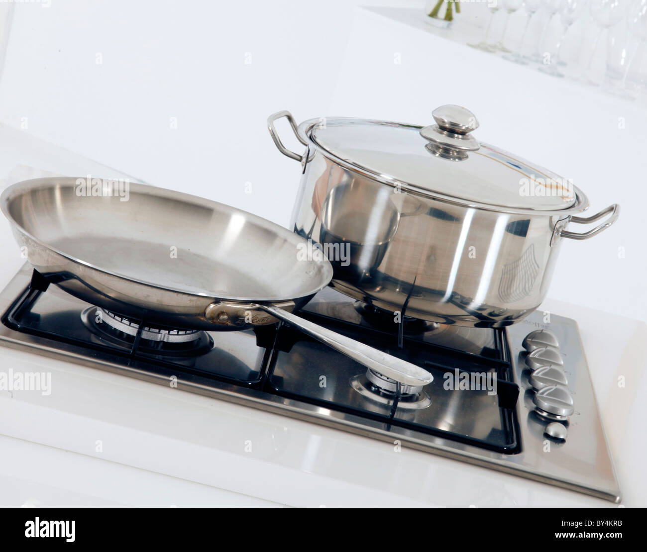 POT AND FRYING PAN ON COOKER HOB Stock Photo