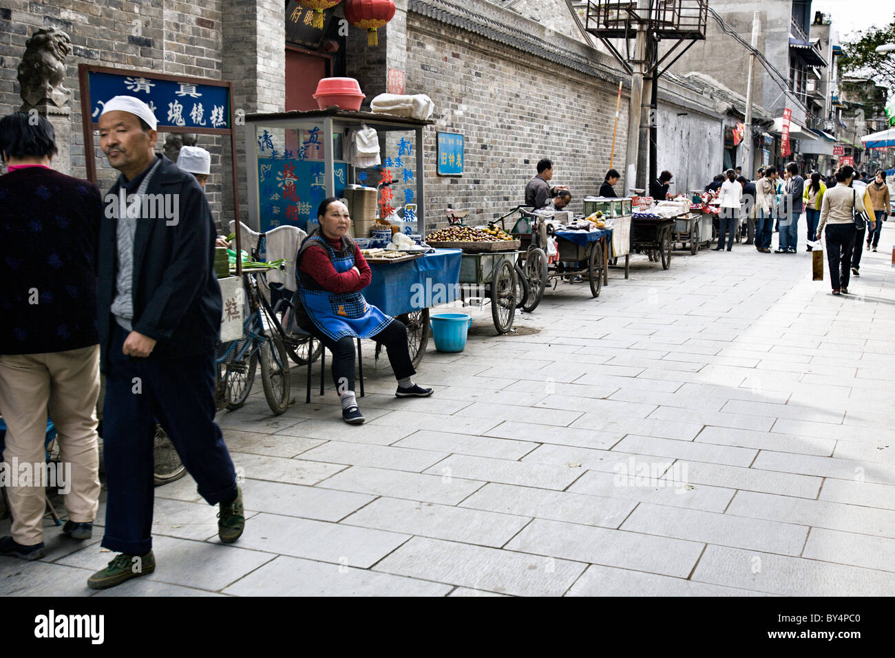 CHINA, XIAN Chinese vendors selling vegetables and food along a