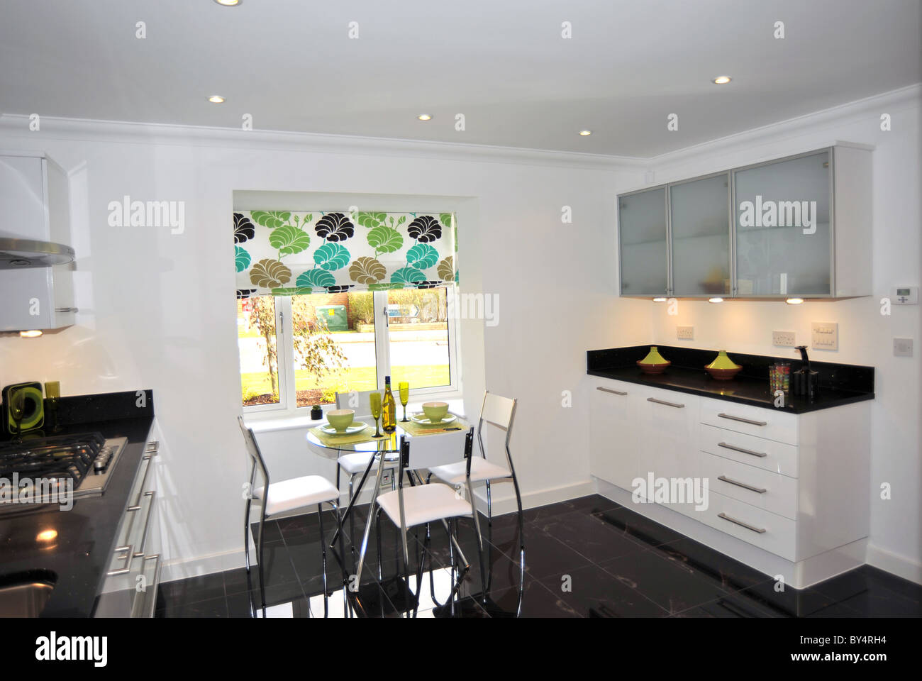 Modern show home kitchen with black granite worktops Stock Photo