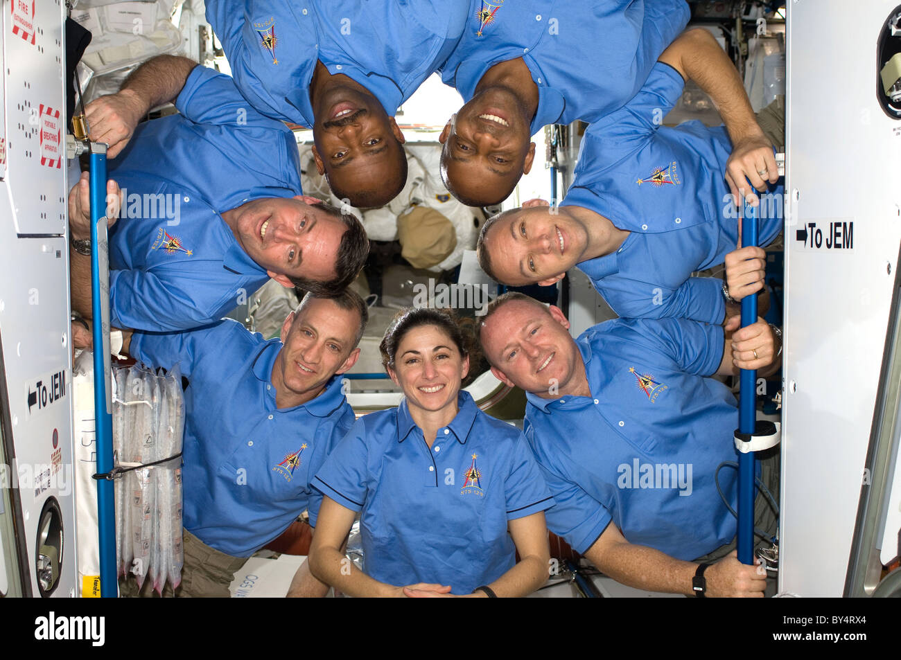 STS 129 Astronauts pose for photo in International Space Station docked to Space Shuttle Atlantis Stock Photo