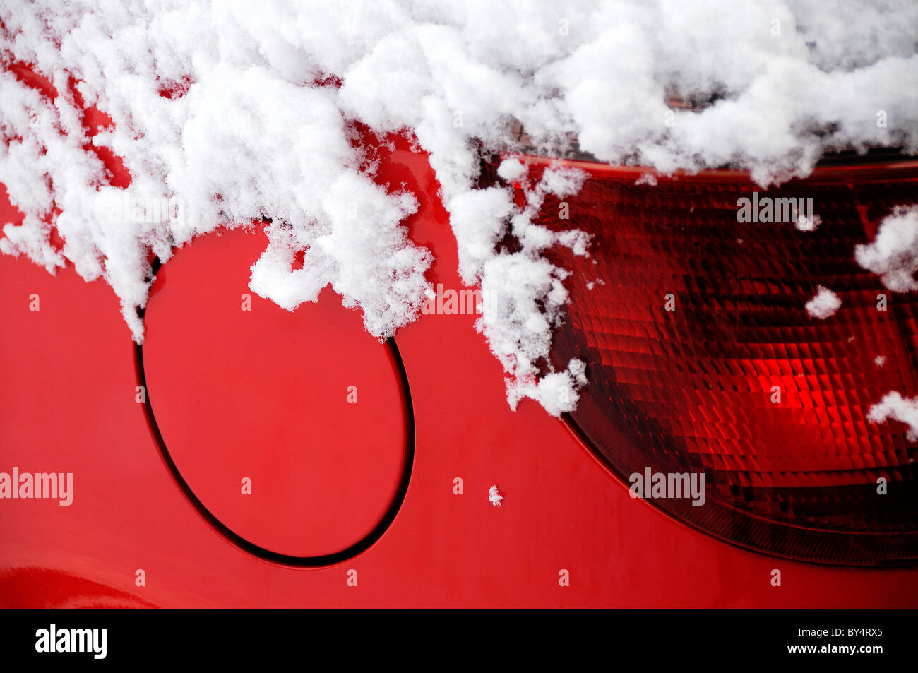 petrol cap of red car in snow Stock Photo