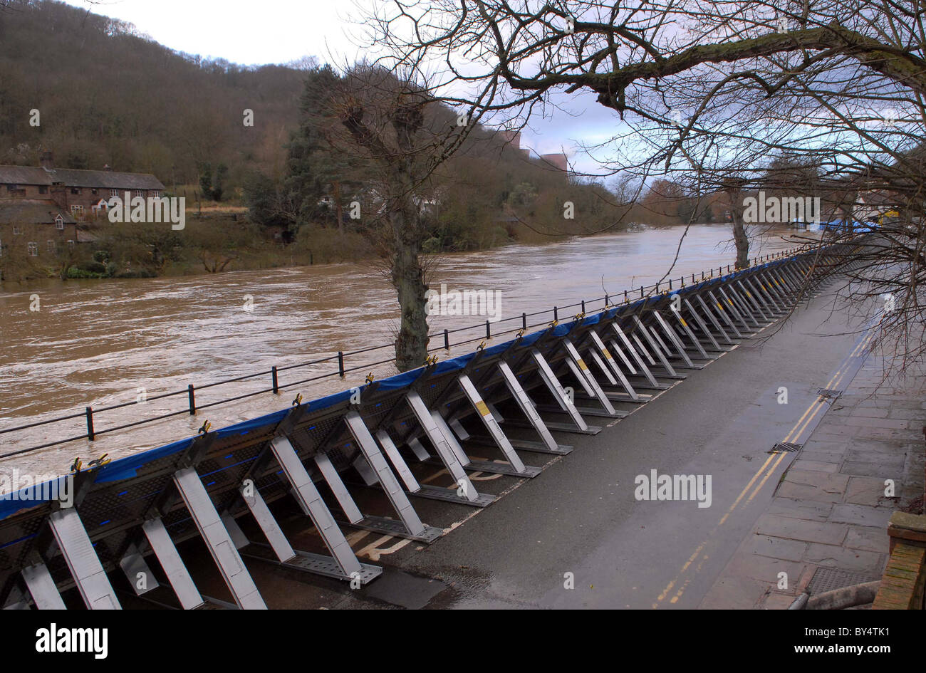 Flood defence barriers hold back flood water in Ironbridge Stock Photo ...