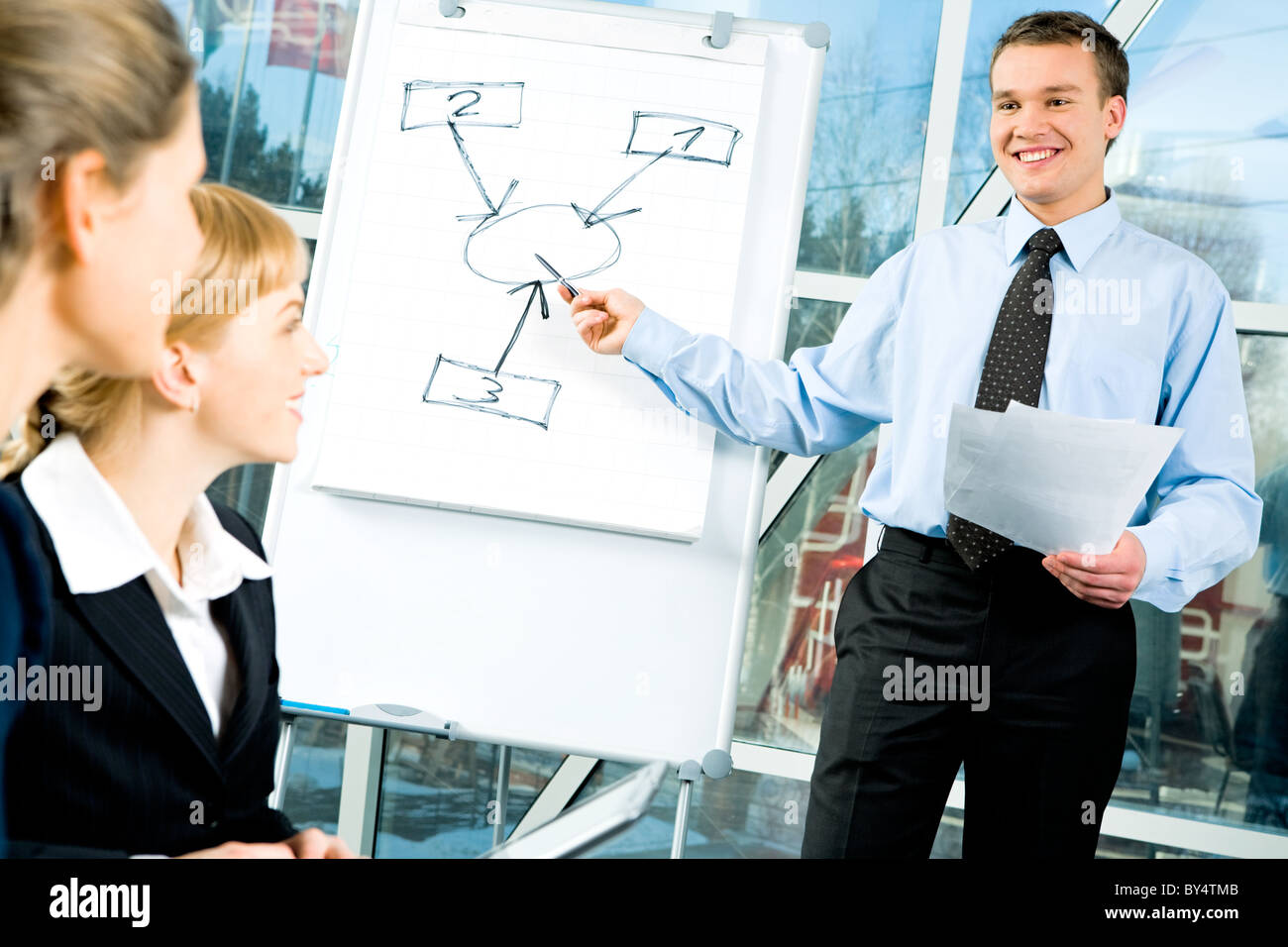 Image of young manager giving a presentation to some colleagues Stock ...