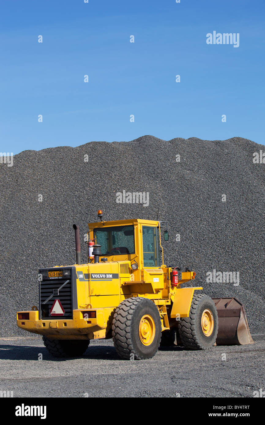 Yellow Volvo BM L90C front loader and a pile of gravel , Finland Stock Photo