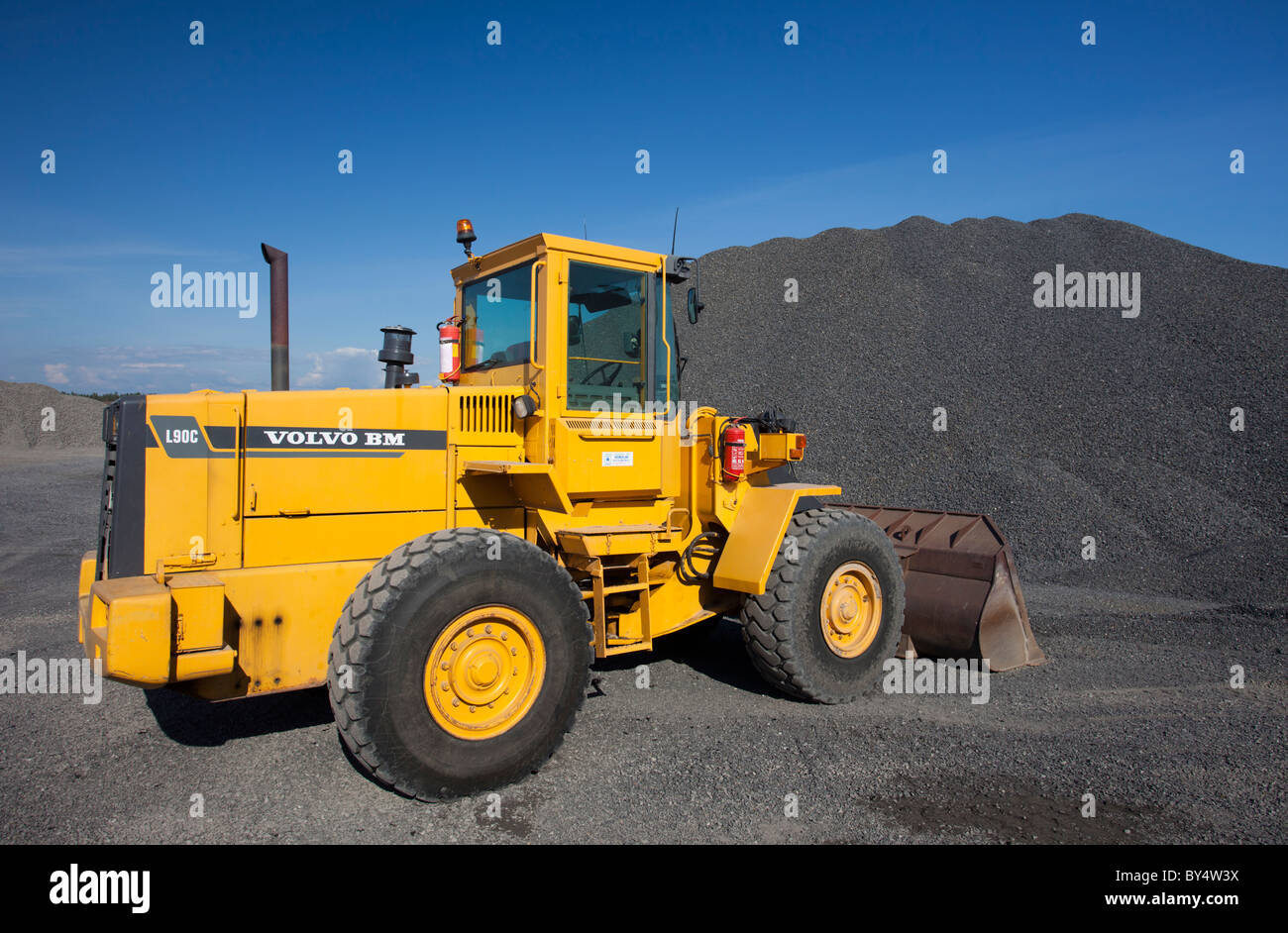 Yellow Volvo BM L90C front loader and a pile of gravel , Finland Stock  Photo - Alamy