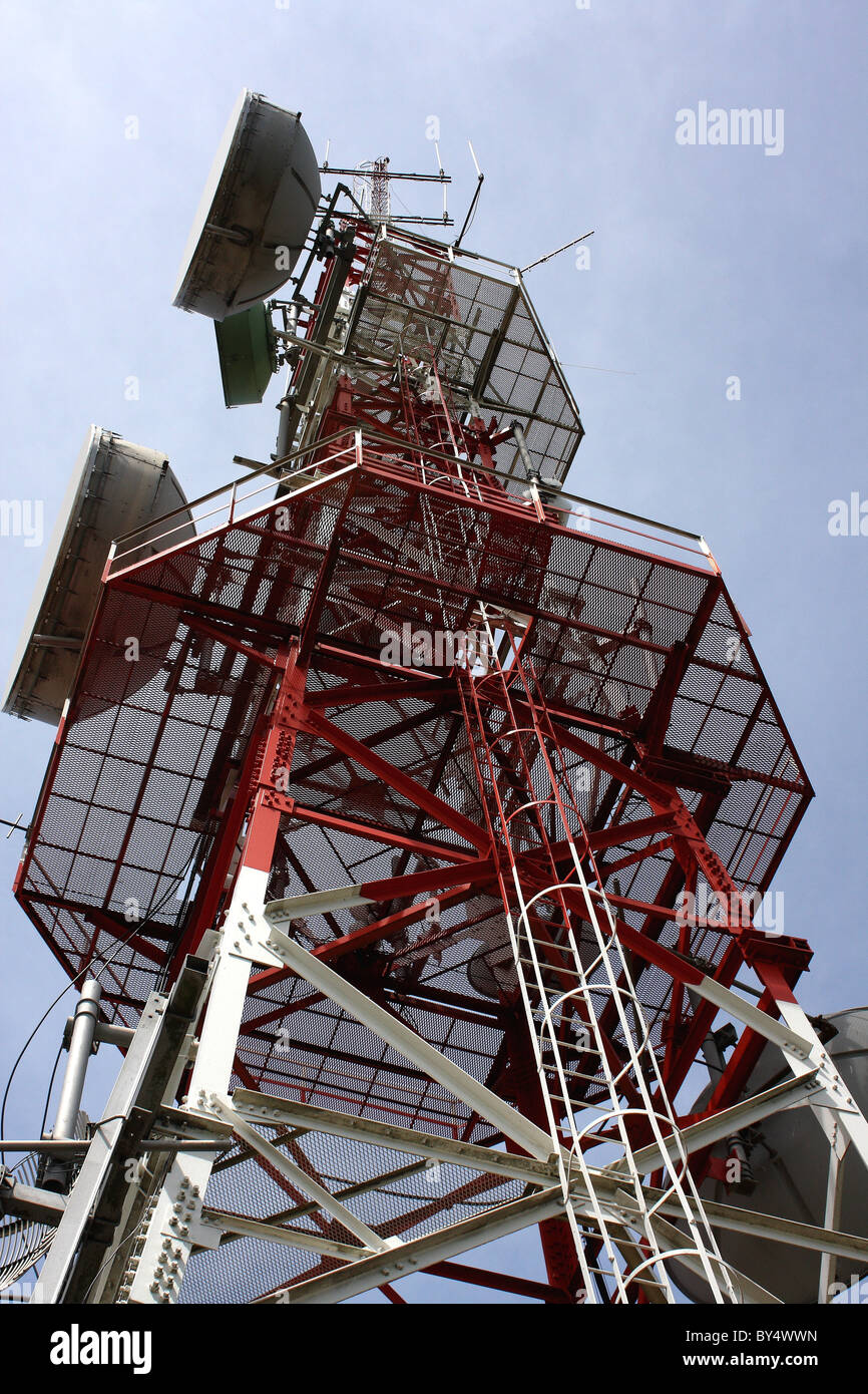 A mast with satellite dishes for digital communication sending signals Worldwide Stock Photo