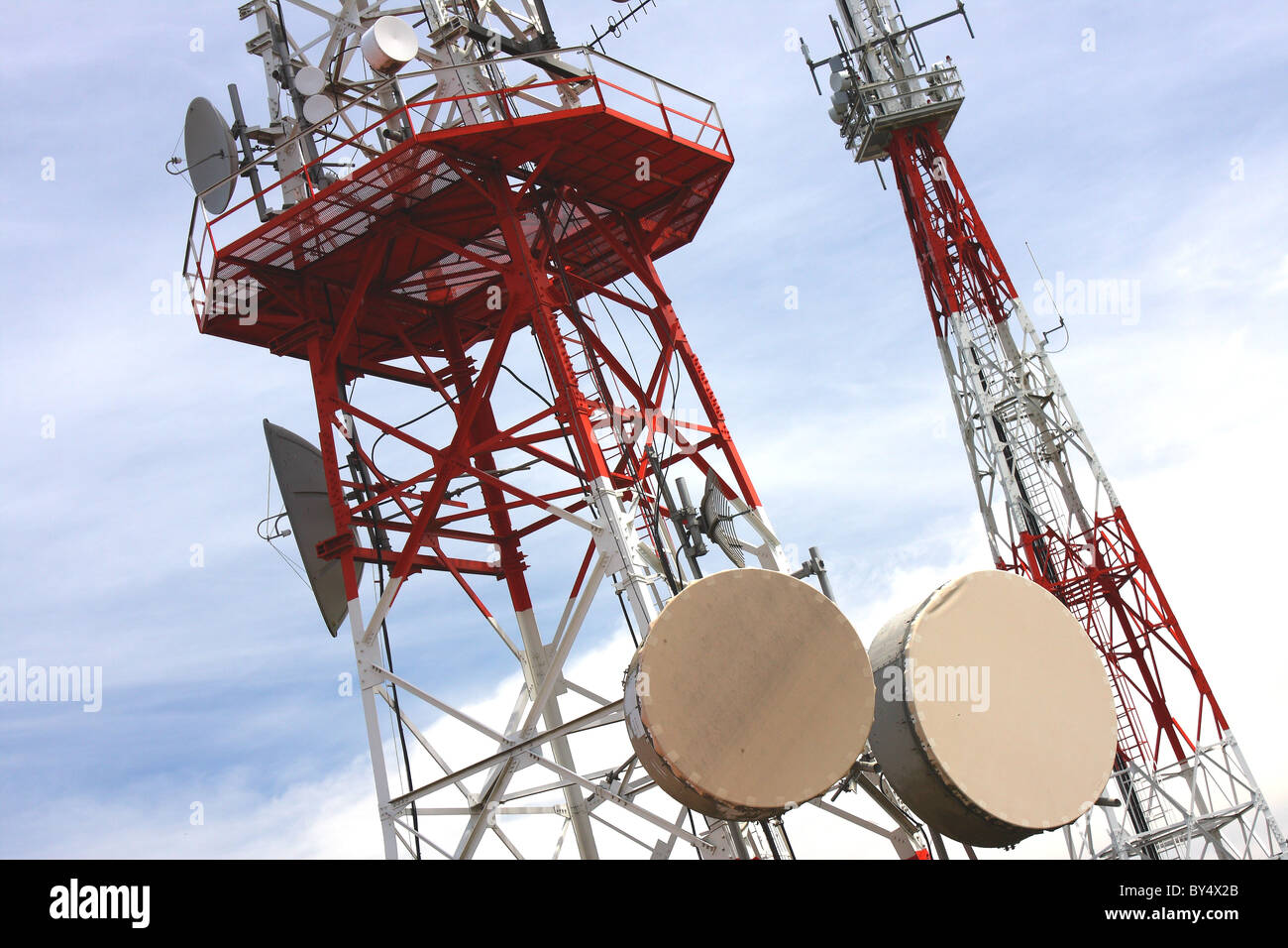 A mast with satellite dishes for digital communication sending signals Worldwide Stock Photo