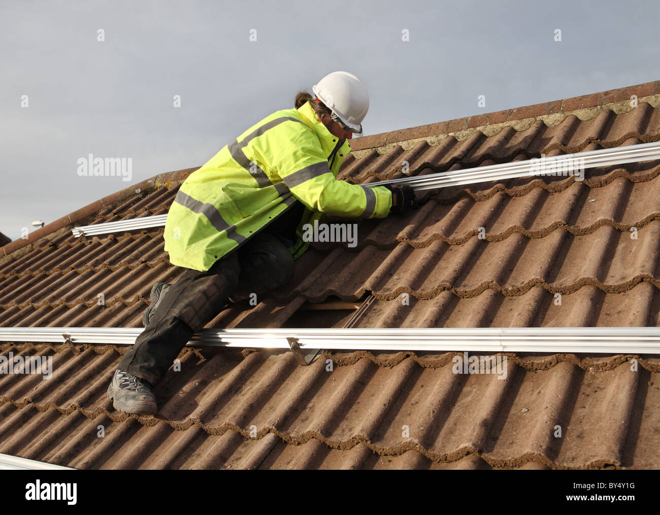 Installing photo voltaic solar panels onto the roof of a domestic house