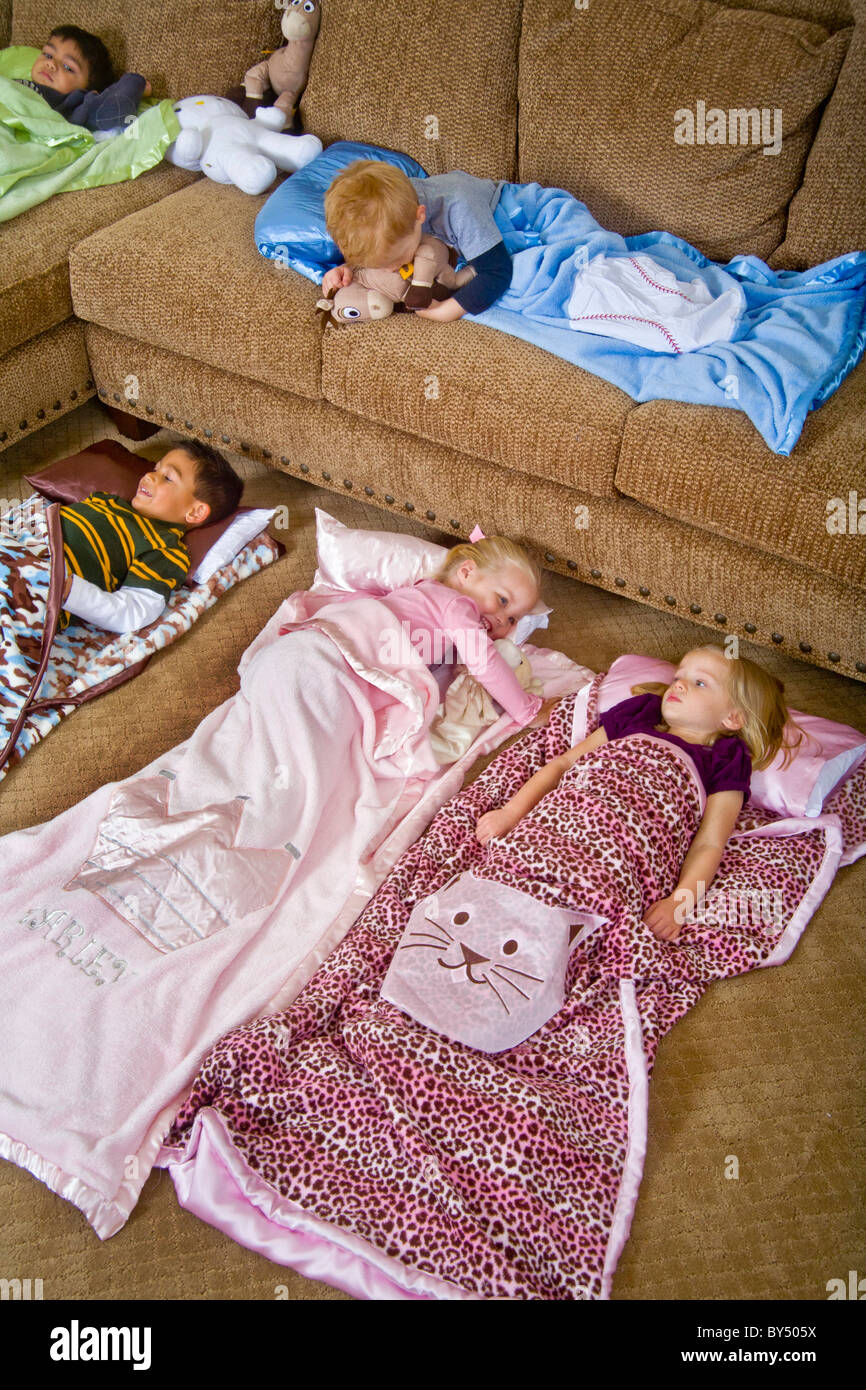 Children bed down for a sleepover in special junior size sleeping bags in Southern California. MODEL RELEASE Stock Photo