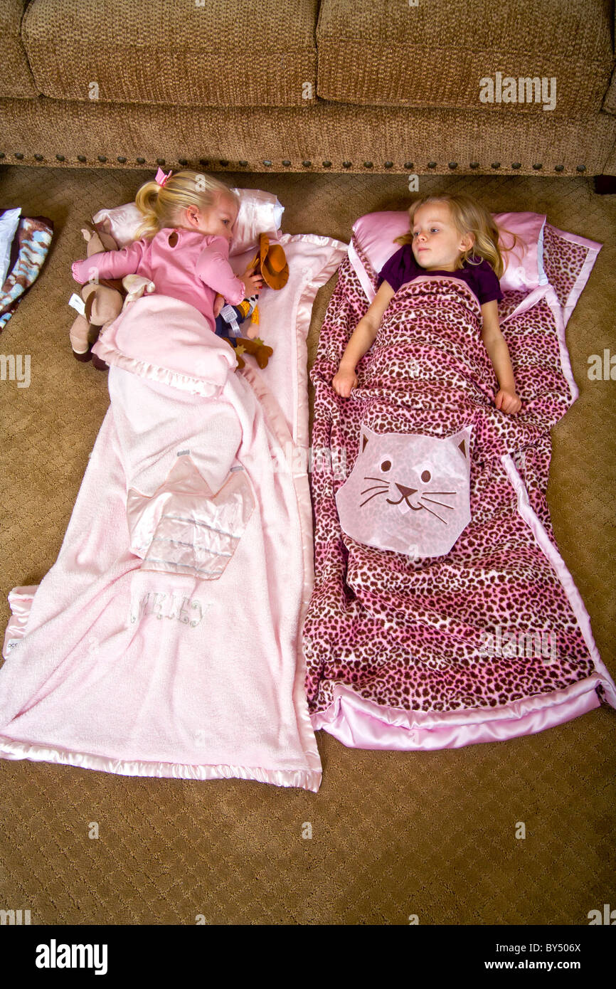 Children bed down for a sleepover in special junior size sleeping bags in Southern California. MODEL RELEASE Stock Photo