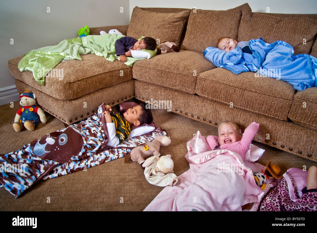 Children bed down for a sleepover in special junior size sleeping bags in Southern California. MODEL RELEASE Stock Photo